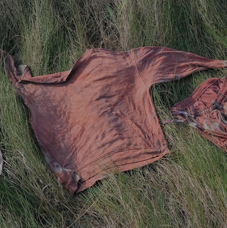 Sun/Lunar bath in field beside sea. 